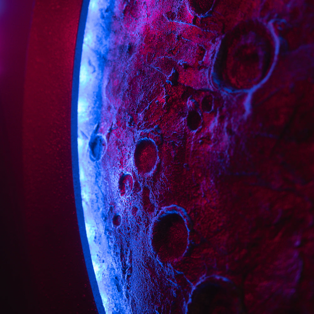 Close-up of a textured surface with blue and red lighting