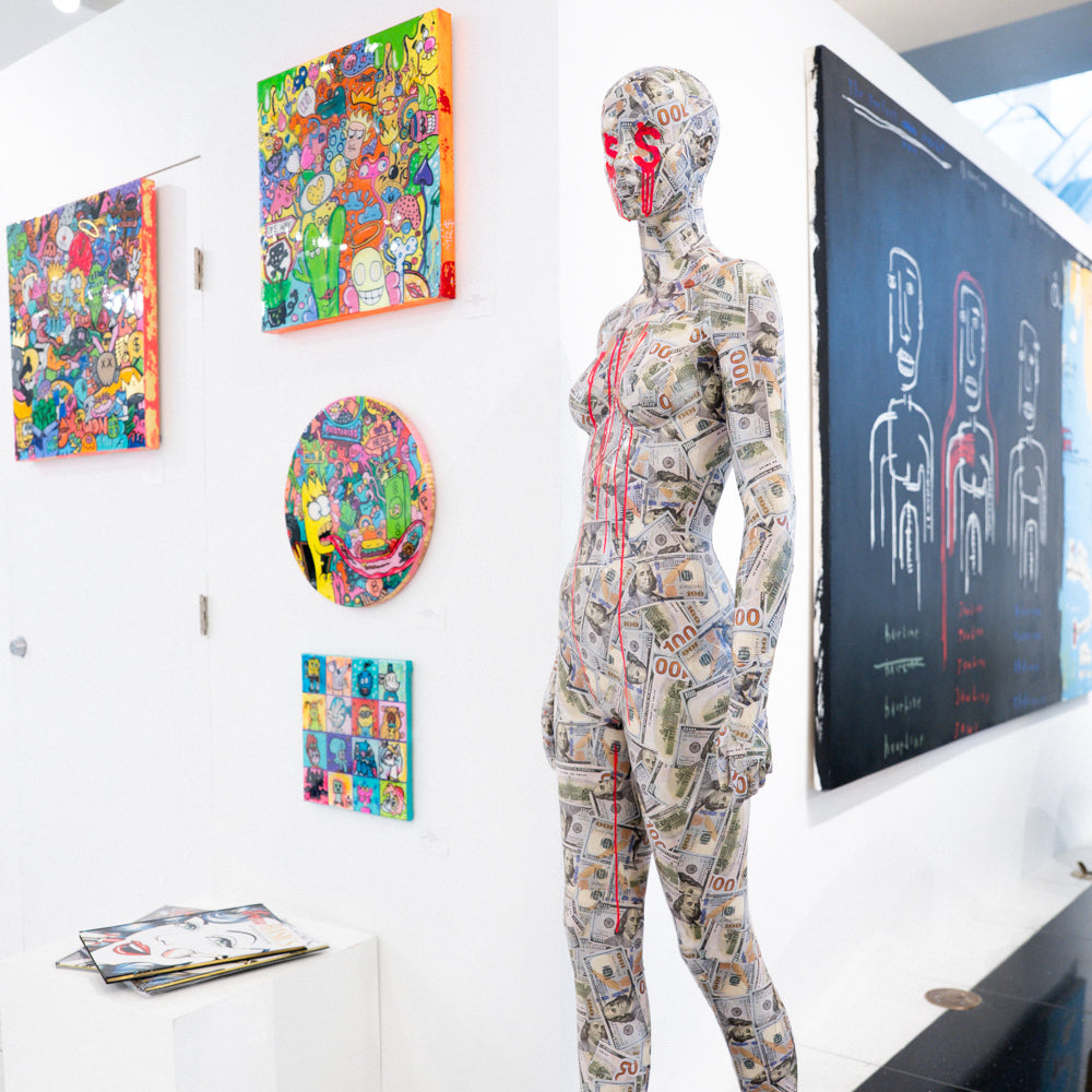 Conceptual mannequin artwork addressing money, power, and emotional detachment.
