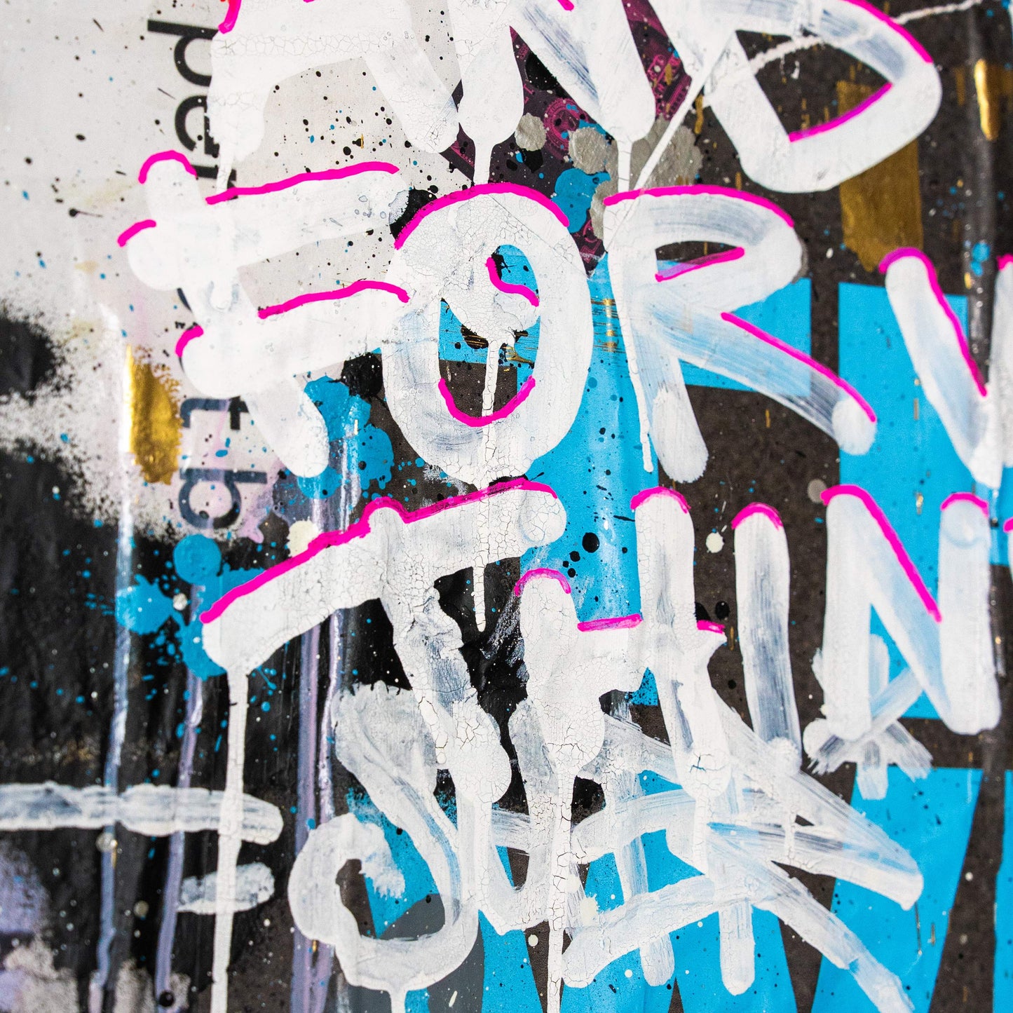 Graffiti-style text with white, pink, and blue colors on a multicolored background