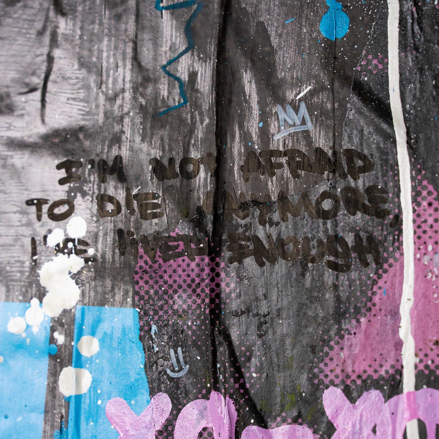 Graffiti on a wall with text and colorful splashes