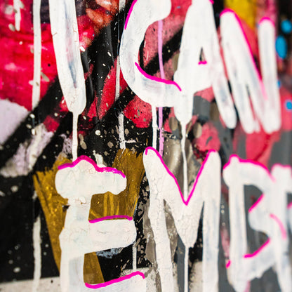 Colorful graffiti-style text with white, pink, and gold letters on a multicolored background.