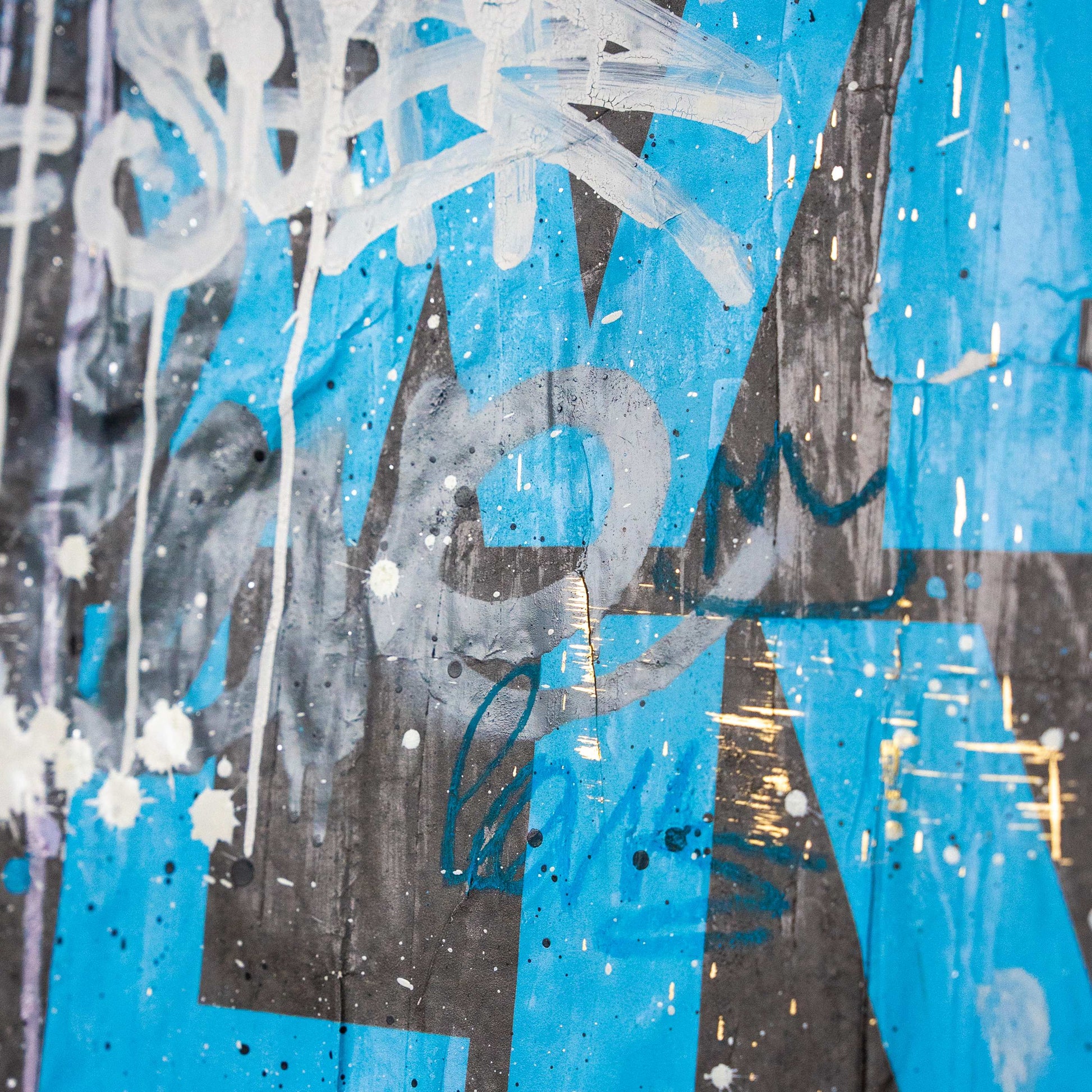 Abstract art with blue, gray, and white colors on a textured surface.