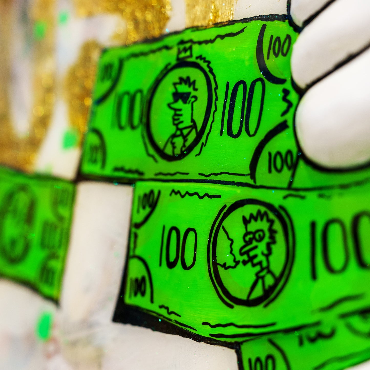 Green dollar bill-themed candy bars held by a gloved hand.
