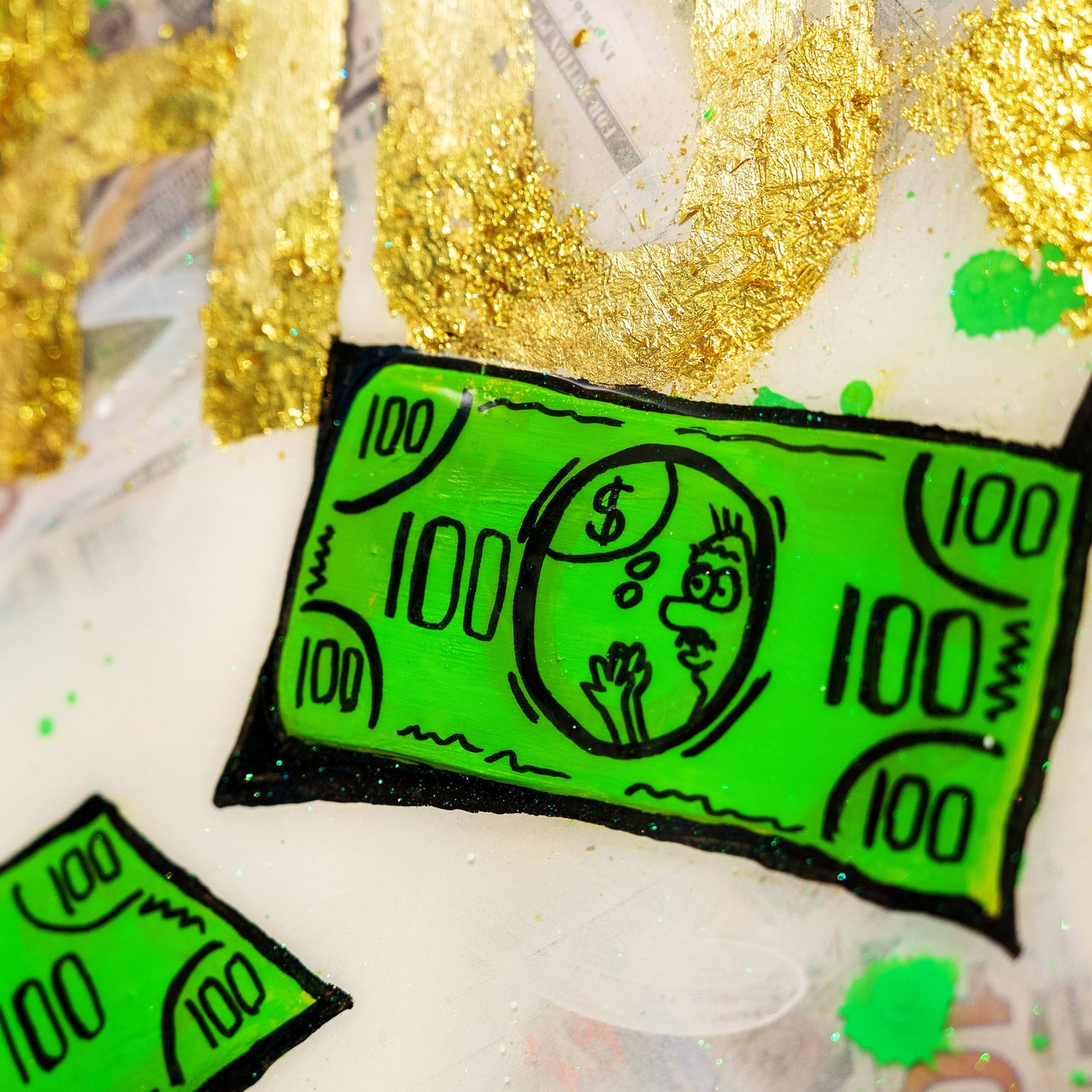 Green hundred-dollar bill stickers on a textured surface with gold accents