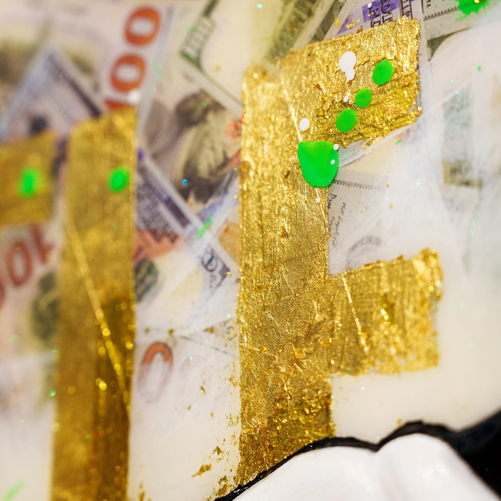 Gold phone case with green accents on a background of money