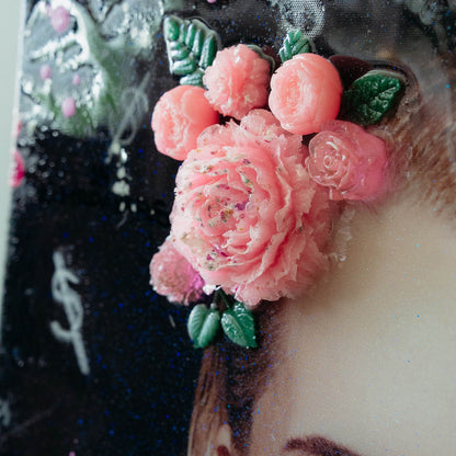 Close-up of pink floral design on a cake with blurred background