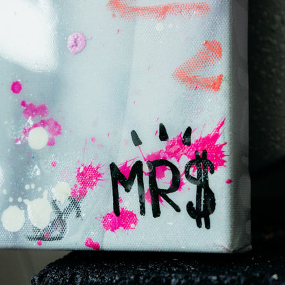 Canvas with 'MRS' text and colorful splashes on a textured background