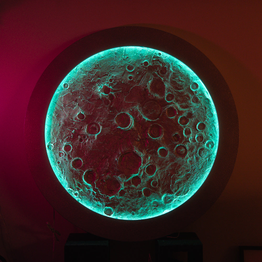 Glowing moon-like object with textured surface on a dark background