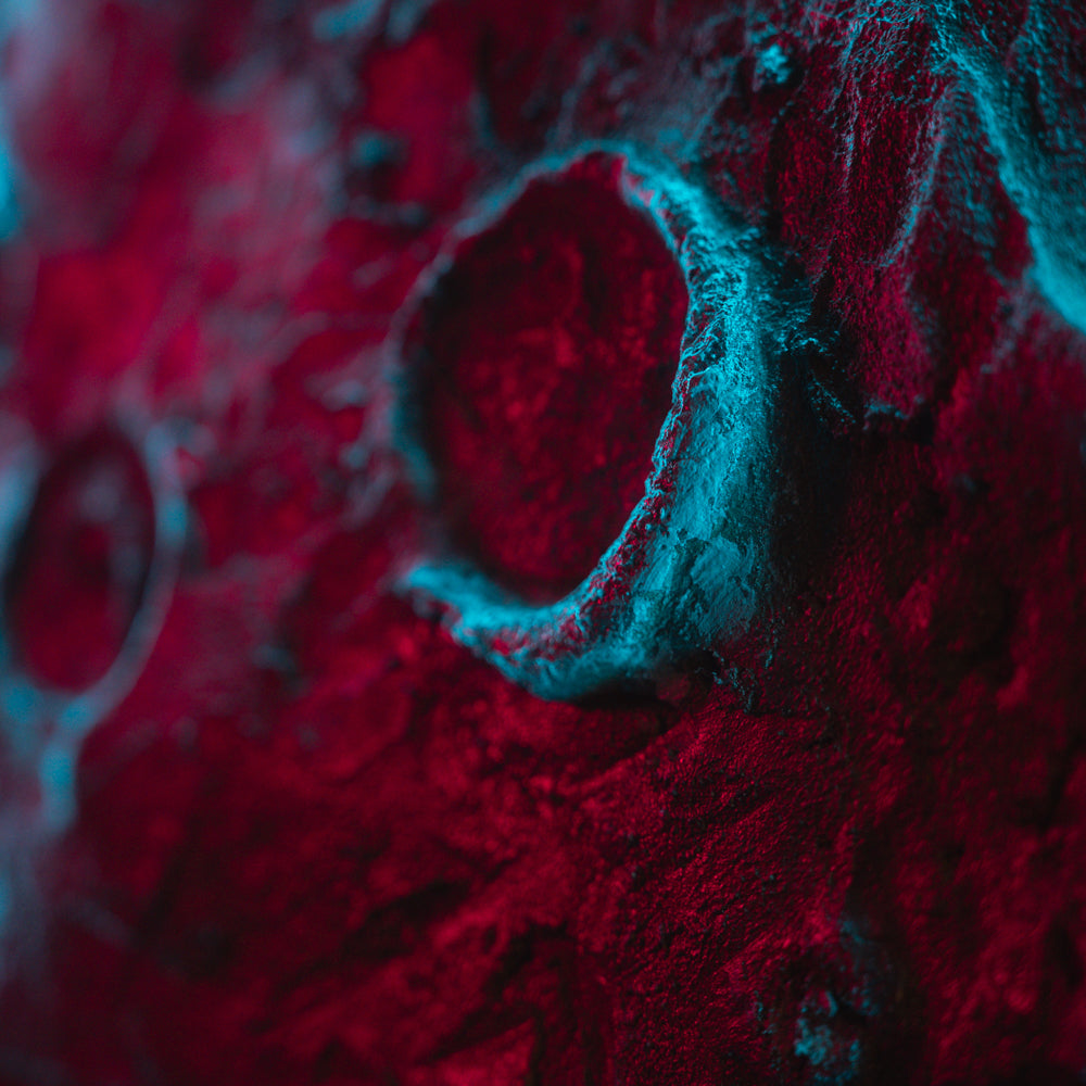 Close-up of a textured surface with red and blue colors