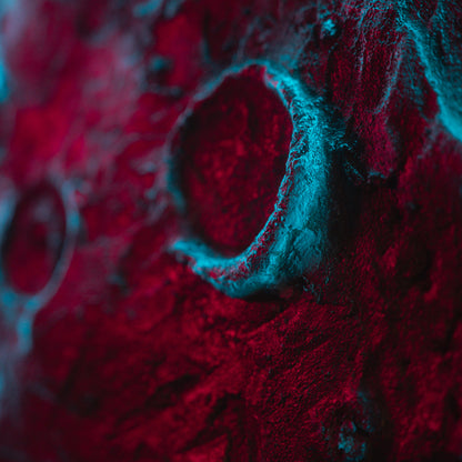 Close-up of a textured surface with red and blue colors