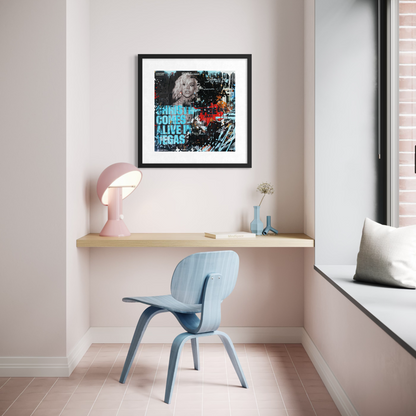 Modern room interior with a desk, chair, and framed artwork on a wall.